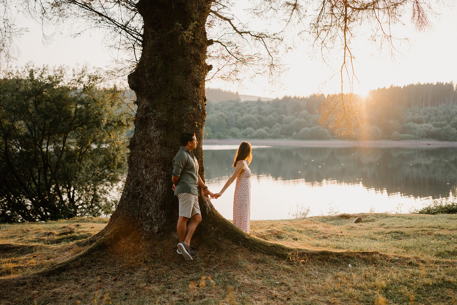 Tara and Matthew by the lake at golden hour